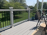 <b>White Trex Composite Railing with black round aluminum balusters and white eyeball light on post 2</b>